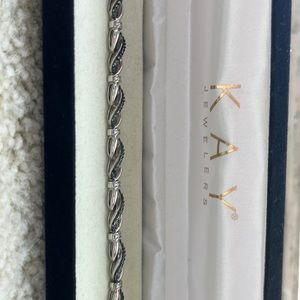 Gently used sterling silver and blue diamond bracelet.